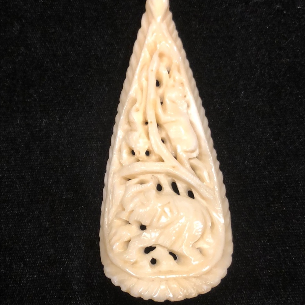 Fake ivory necklace with beads and carvings.